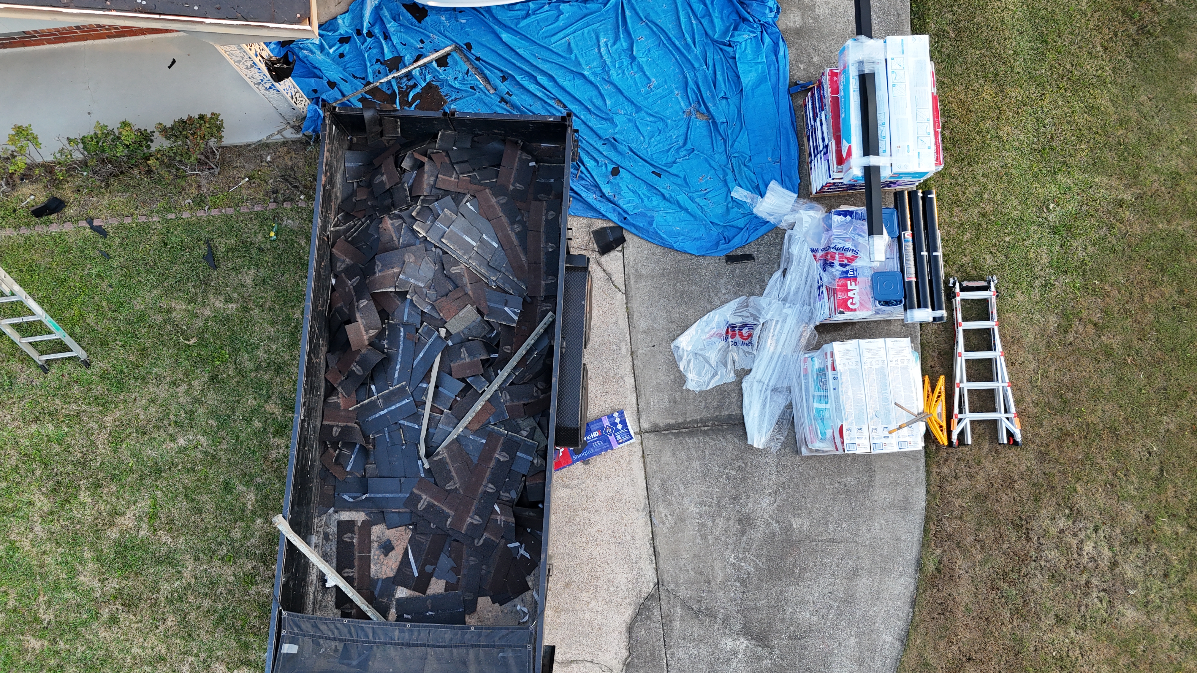 Old shingles removed, new materials staged